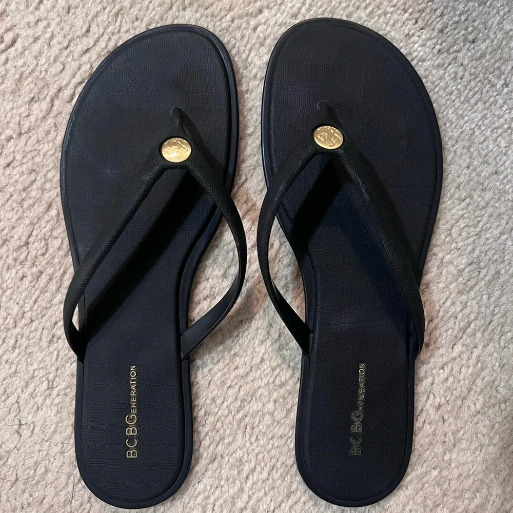 BCBGeneration Black Thong Sandals with Gold Logo Accent